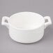 A white porcelain cocotte with two handles.