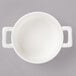 A white Bon Chef porcelain bowl with two handles.