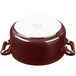 A white porcelain casserole with brown accents and handles.