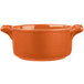 An orange porcelain Bon Chef cocotte with handles.