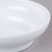 A close up of a white Thunder Group melamine salsa bowl.