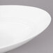 A white Bon Chef slanted oval bowl with a curved rim.