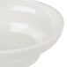 A white melamine salsa dish with a handle.