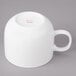 A white porcelain cappuccino cup with a handle.