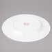 A white Bon Chef bone china salad plate with a wide rim.