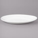 A white Bon Chef porcelain oval plate with a curved edge.