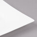 A close-up of a Bon Chef white bone china saucer with a wide white rim.