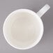 A white Bon Chef porcelain cup with a handle.