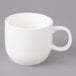 A white porcelain cup with a handle.