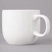 A white porcelain cup with a handle.