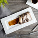 A white rectangular Bon Chef bone china plate with food on it.