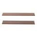 Two brown wooden Elevation shelves with assorted sizes on a table.