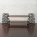 A wooden shelf set with black metal legs and rods.