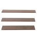 A row of three wooden Elevation walnut shelves with different sizes and shapes on a table.
