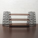 A wood shelf set with metal towers on a wood surface.