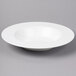 A white Bon Chef bone china pasta plate on a gray surface.