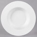 A white plate with a wide round rim.