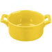 A yellow porcelain Bon Chef cocotte with handles.