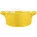 A yellow porcelain Bon Chef cocotte with handles.