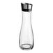 A clear glass decanter with a silver lid.