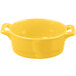 A yellow porcelain oval cocotte with handles on a white background.