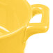 A close-up of a yellow porcelain Bon Chef oval cocotte with handles.