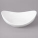 A white Bon Chef porcelain pasta bowl with a curved edge.