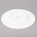 A white Bon Chef bone china dinner plate with a wide rim.