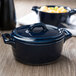 A cobalt blue porcelain oval cocotte lid on a blue pot.