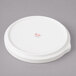 A white porcelain Bon Chef bread and butter plate with stacked lines.