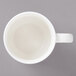A Bon Chef white porcelain cup with a handle.