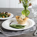 A white Bon Chef porcelain oval dinner plate with food on it.
