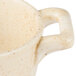 A close up of a white porcelain oval cocotte with a wheat design.