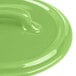 A green Bon Chef porcelain lid with a handle.