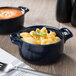 Two cobalt blue Bon Chef porcelain cocottes filled with macaroni and cheese.