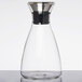 A clear glass decanter with a stainless steel lid.