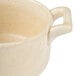 A white porcelain Bon Chef cocotte with a handle.