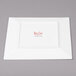 A white square plate with red text on it.