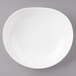 A Bon Chef white porcelain pasta bowl on a gray surface.