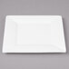 A white square Bon Chef bone china plate with a wide white rim.