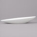 A close up of a white Bon Chef slanted oval bowl.