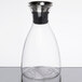 A clear glass decanter with a stainless steel lid.