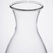 A clear glass decanter with a round neck and a stainless steel lid.