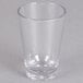 A clear Carlisle SAN plastic shooter/dessert shot glass on a white surface.