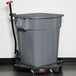 A Rubbermaid BRUTE 40 gallon grey plastic bin on a floor.