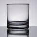 A close up of a Libbey Lexington Rocks glass on a reflective surface.