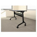 A black metal table base with wheels.