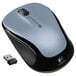 A Logitech silver wireless mouse next to a USB stick.