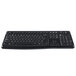A close-up of a black Logitech K120 wired keyboard with curved keys.