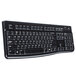 A close-up of a black Logitech K120 keyboard with white text on a black stripe.